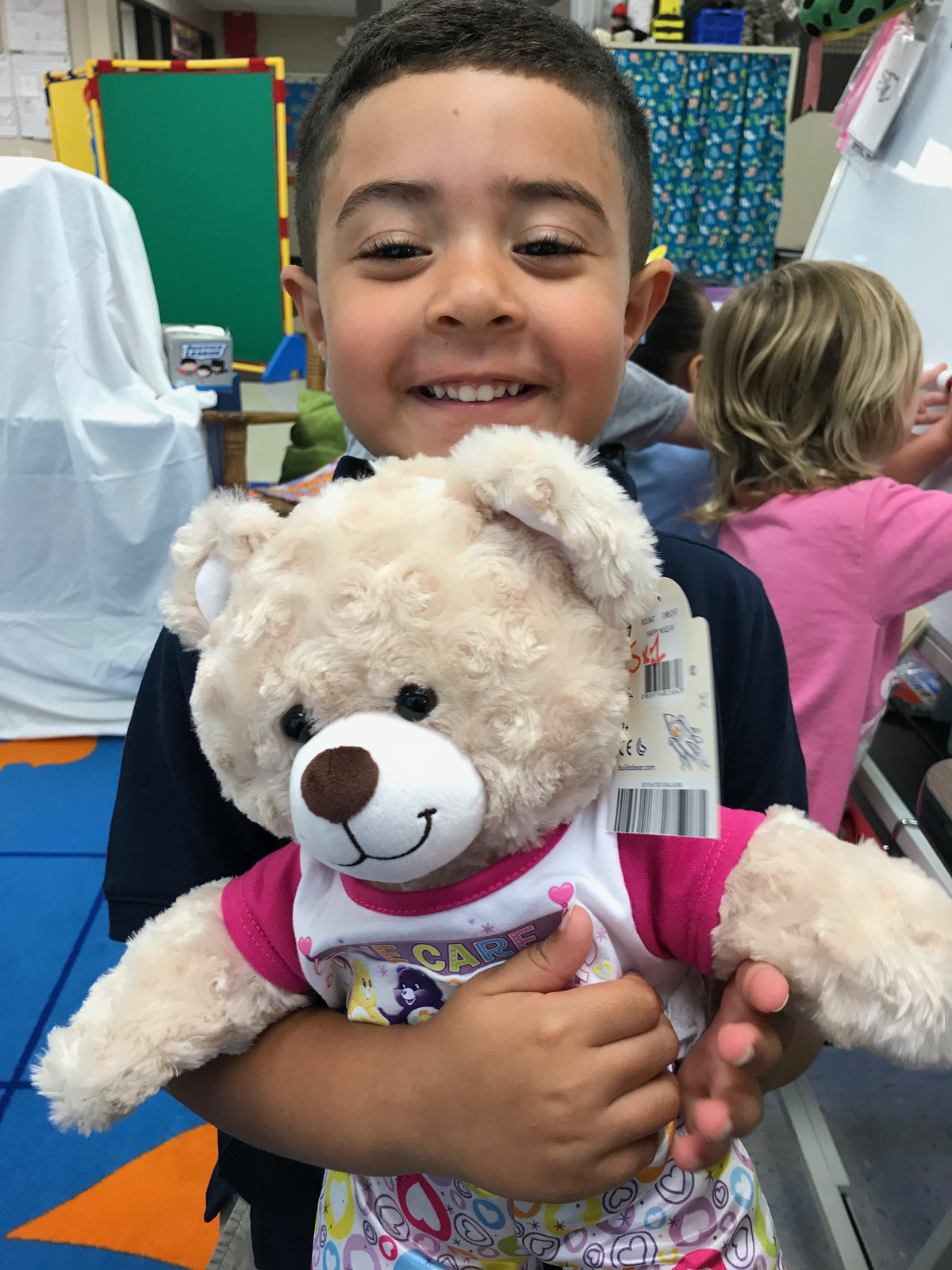 Catholic preschooler holds care bear