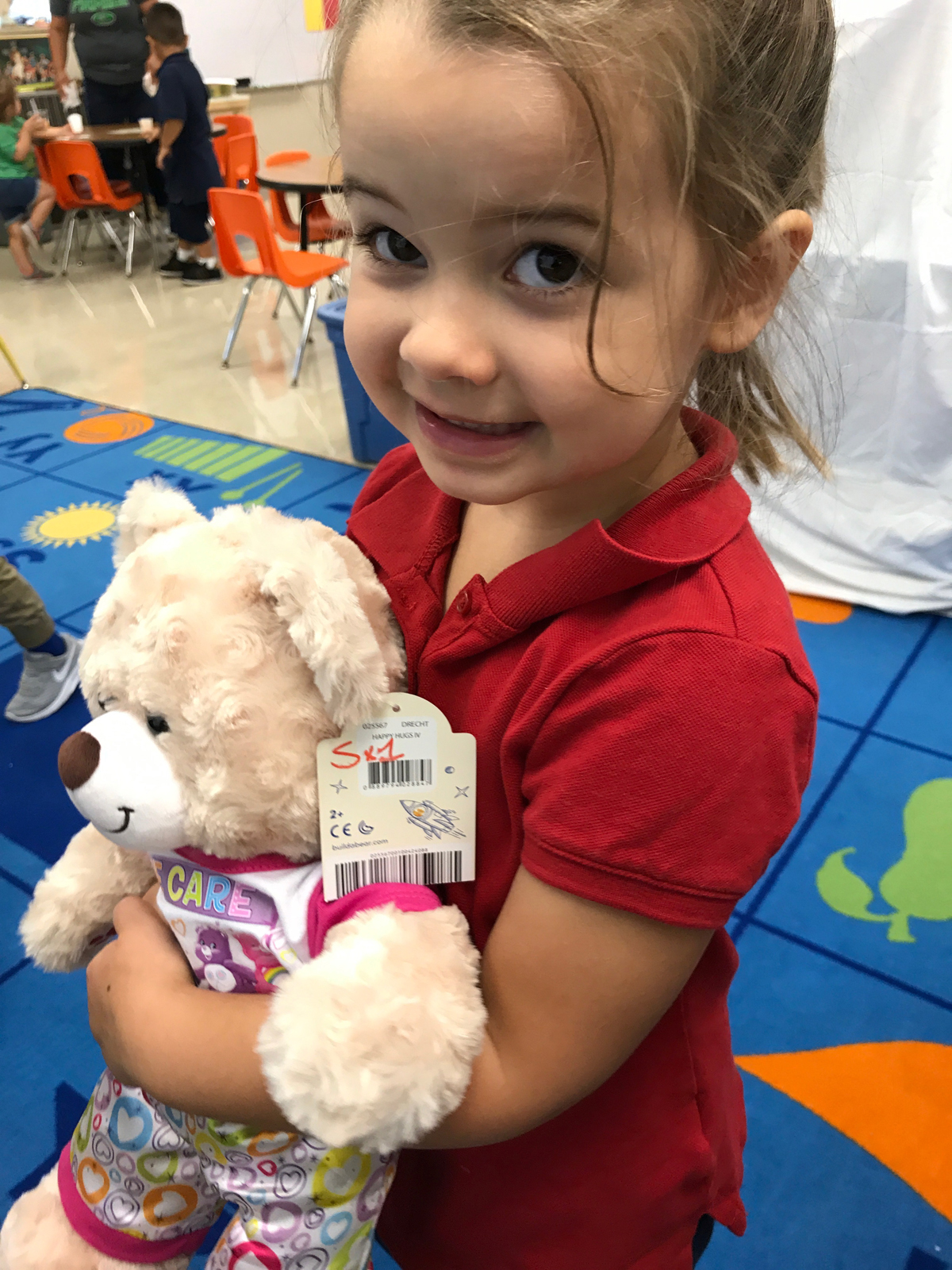 Catholic preschooler holds care bear