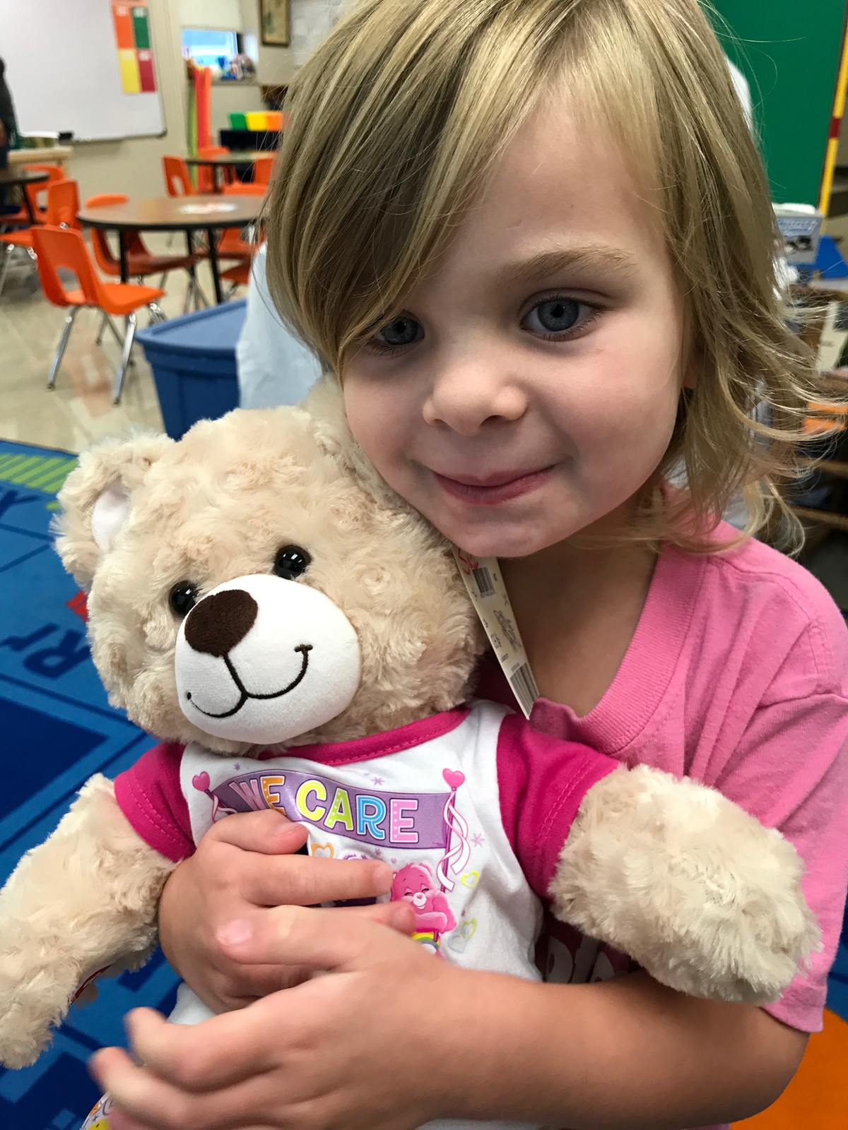 Catholic preschooler holds care bear