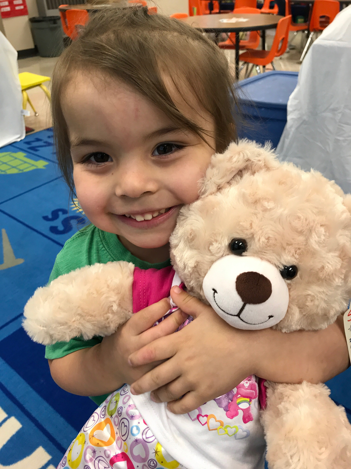 Catholic preschooler holds care bear