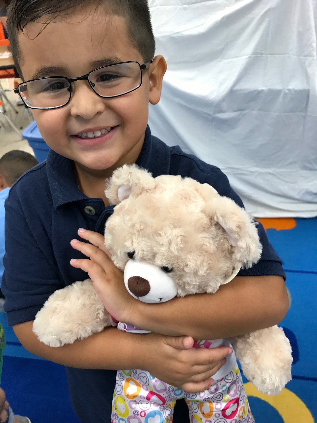 Catholic preschooler holds care bear