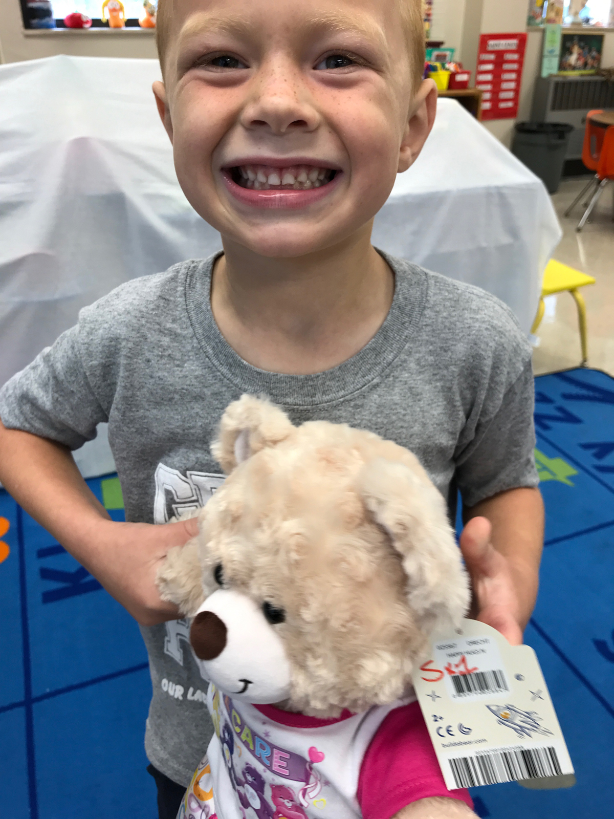 Catholic preschooler holds care bear