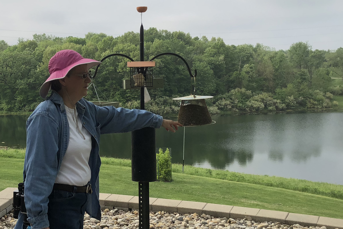 Catholic Benedictine Sister Claudia Scharf at monastery birdfeeders