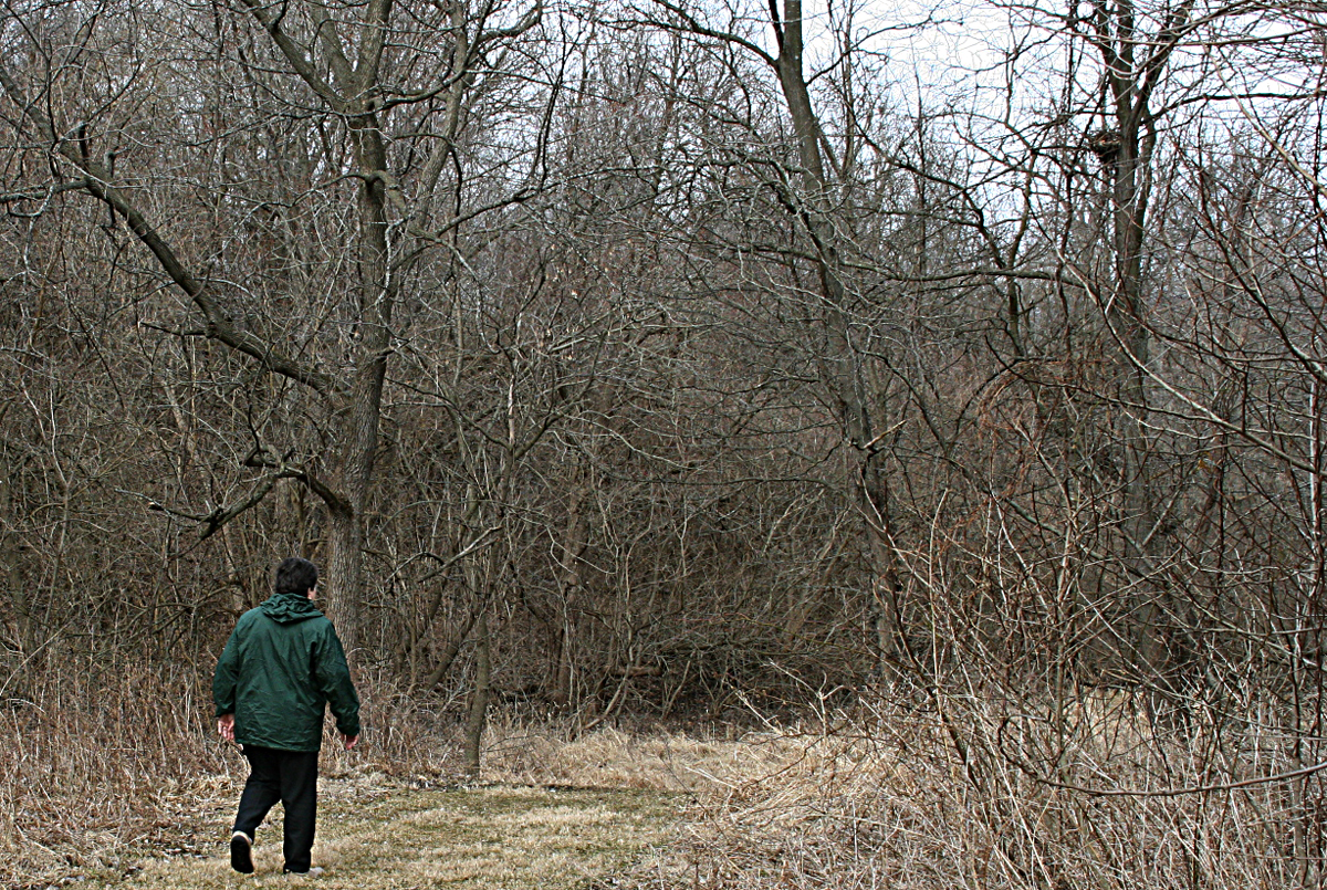 Benedictine Sister Mary Core walks in monastery woods